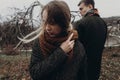 stylish hipster woman and man posing in windy autumn park. sensual atmospheric moment with space for text. fashionable cool Royalty Free Stock Photo