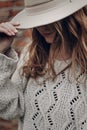 Stylish hipster woman posing in knitted sweater on background o Royalty Free Stock Photo