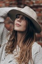 Stylish hipster woman posing in knitted sweater on background o Royalty Free Stock Photo