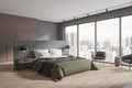 Stylish home bedroom interior with bed and armchairs, panoramic window