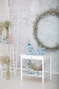Stylish home decor in blue is a wooden basket, decorative nesting boxes and a cute rabbit. Easter decorations. Summer village comp