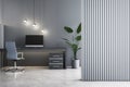 Stylish home office setup with computer and pendant lights against a striped wall. Modern interior design. Royalty Free Stock Photo