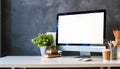 Stylish home or studio workspace with computer, supplies, plant, and books. Empty screen for graphic montage