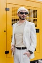 Stylish homosexual man in beige suit