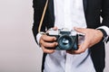 Stylish image of retro camera in hands of handsome guy in suit. Leisure, journalist, photograph, hobbies, having fun. Royalty Free Stock Photo