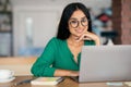 Stylish indian woman independent contractor working online at cafe
