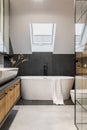 Stylish interior of bathroom with bathtub, shower, towels and other personal bathroom accessories. Modern and design interior. Royalty Free Stock Photo