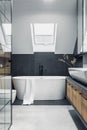 Stylish interior of bathroom with bathtub, shower, towels and other personal bathroom accessories. Modern and design interior Royalty Free Stock Photo
