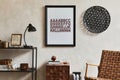 Stylish interior design composition of elegant masculine living room with mock up poster frame, brown armchair, industrial.