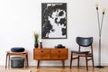 Vintage living room with wooden commode and poster of map. Royalty Free Stock Photo