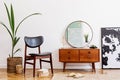 Vintage living room with wooden commode and round mirror. Royalty Free Stock Photo