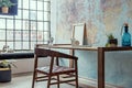 Stylish interior design of office space in loft apartment with wooden desk, chair, office supplies, cacti, table lamp and elegant.