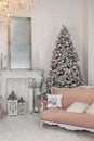 Stylish interior of living room with Christmas tree and lights glowing garlands. Cozy decorated room for Xmas. Decorated Christmas Royalty Free Stock Photo