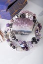 Stylish jewelry bracelet with semiprecious and amethyst  crystal around  white background. hobby and fashion concept. close up Royalty Free Stock Photo