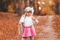 Stylish kid girl in autumn park Royalty Free Stock Photo