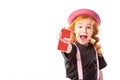 stylish kid in pink hat and suspenders showing smartphone with youtube page