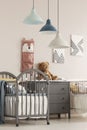 Stylish kid`s bedroom interior with elegant wooden furniture and posters on the wall Royalty Free Stock Photo