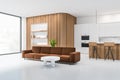 Stylish kitchen interior with sofa and bar seats with shelves, panoramic window Royalty Free Stock Photo