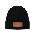 Stylish knit beanie with a brown rectangular patch on the front Royalty Free Stock Photo