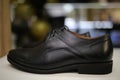 Stylish leather, lacquered mens shoes on the shelf in the store