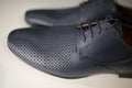 Stylish leather, lacquered mens shoes on the shelf in the store