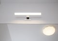 Stylish LED wall light above the bathroom mirror. Modern lighting, close-up Royalty Free Stock Photo