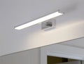 Stylish LED wall light above the bathroom mirror. Modern lighting, close-up Royalty Free Stock Photo