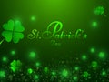 Stylish lettering of St. Patrick`s Day on shamrock leaves decorated green background.