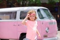 Stylish little boy child wearing a summer pink shirt, funny sunglasses having fun in city over colorful background. Royalty Free Stock Photo