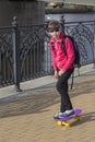 Stylish little girl child riding skateboard in city Royalty Free Stock Photo