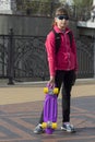 Stylish little girl child riding skateboard in city Royalty Free Stock Photo