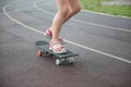 Stylish little girl child with skateboard on the running track Royalty Free Stock Photo