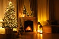 Stylish living room interior with beautiful fireplace, Christmas tree and other decorations at night Royalty Free Stock Photo