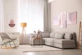 Stylish living room interior with big comfortable sofa and pictures Royalty Free Stock Photo
