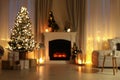 Stylish living room interior with Christmas tree near beautiful fireplace, blurred view Royalty Free Stock Photo