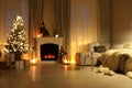 Stylish living room interior with Christmas tree near beautiful fireplace, blurred view Royalty Free Stock Photo