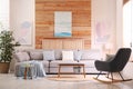 Stylish living room interior with comfortable sofa and pictures Royalty Free Stock Photo