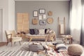 Stylish living room interior design with scandinavian settee, grey wall and natural accents Royalty Free Stock Photo