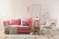 Stylish living room interior with sofa and rocking armchair Royalty Free Stock Photo