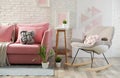 Stylish living room interior with sofa and rocking armchair Royalty Free Stock Photo