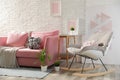 Stylish living room interior with sofa and rocking armchair Royalty Free Stock Photo
