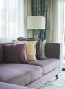 Stylish living room with purple sofa and colorful pillows Royalty Free Stock Photo