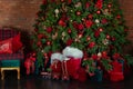 Stylish loft interior of room with Christmas fir tree and checkered armchair. Royalty Free Stock Photo