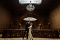 Stylish luxury bride and handsome elegant groom dancing on the b
