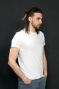 Stylish male model with long hair and beard posing in studio. Modeling, hairstyle, fashion concept. Royalty Free Stock Photo