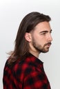 Stylish male model with long hair and beard posing in studio. Modeling, hairstyle, fashion concept. Royalty Free Stock Photo