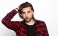 Stylish male model with long hair and beard posing in studio. Modeling, hairstyle, fashion concept. Royalty Free Stock Photo