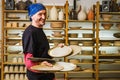 Stylish male potter master holding pottery art products in his workshop