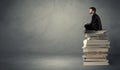 Stylish male seated on books Royalty Free Stock Photo