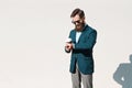 Stylish man with beard wearing a jacket, shirt and bow tie on a sunny day Royalty Free Stock Photo